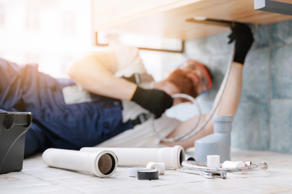 plumber fixing drain